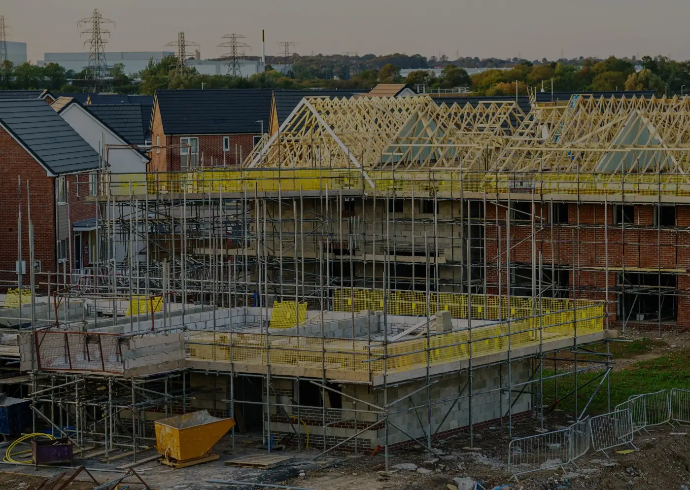 New build houses under construction with roof trusses and scaffolding